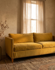 Mustard velvet sofa, three-quarter view from the right