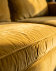 Macro of the mustard velvet nap and piped cushion seam