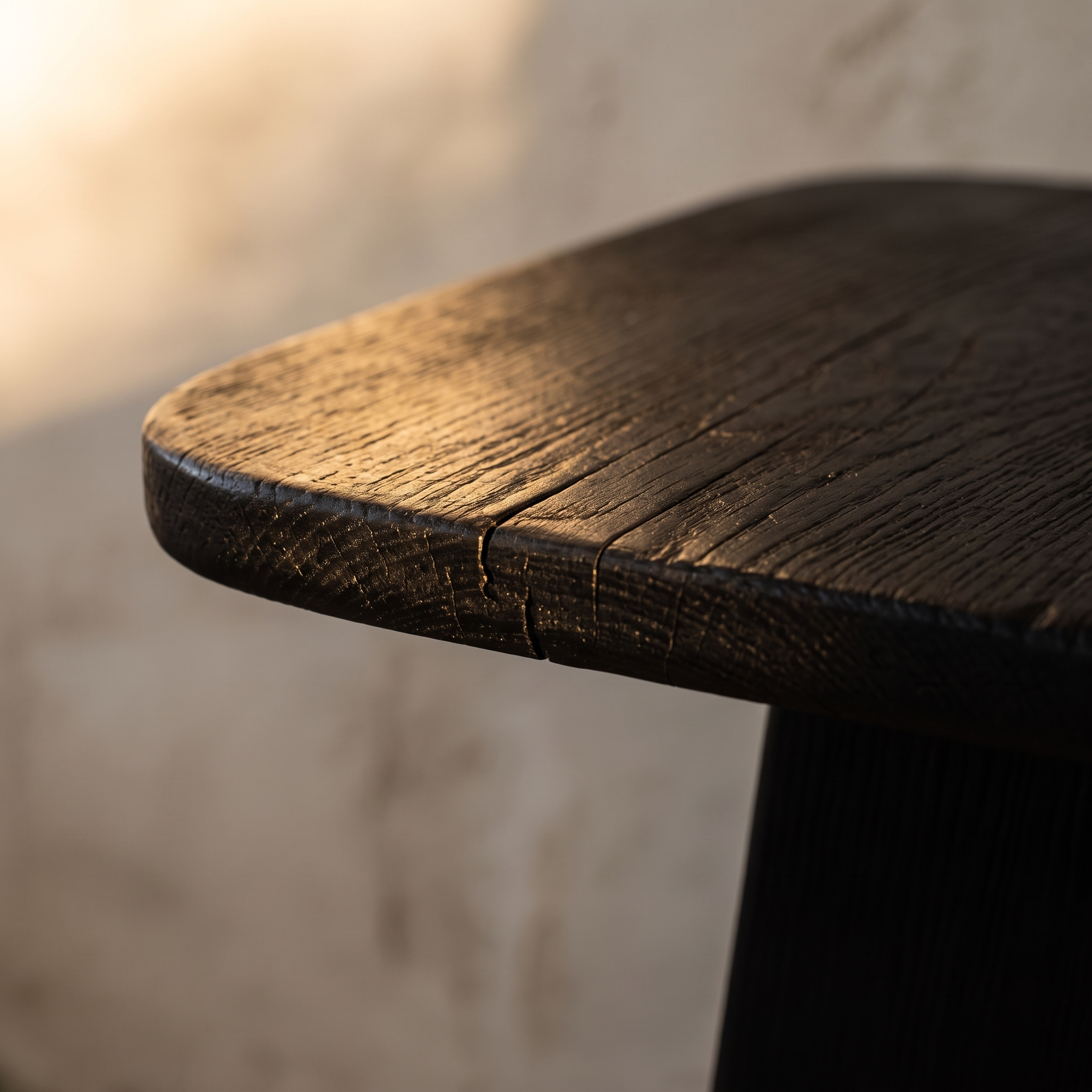 Macro detail of the charred wood grain and rounded edge of the Ember Side Table