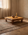 Antique honey Indian bajot table in a warm plaster OE room