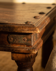Detail of iron corner bracket and nailhead studs on the bajot table