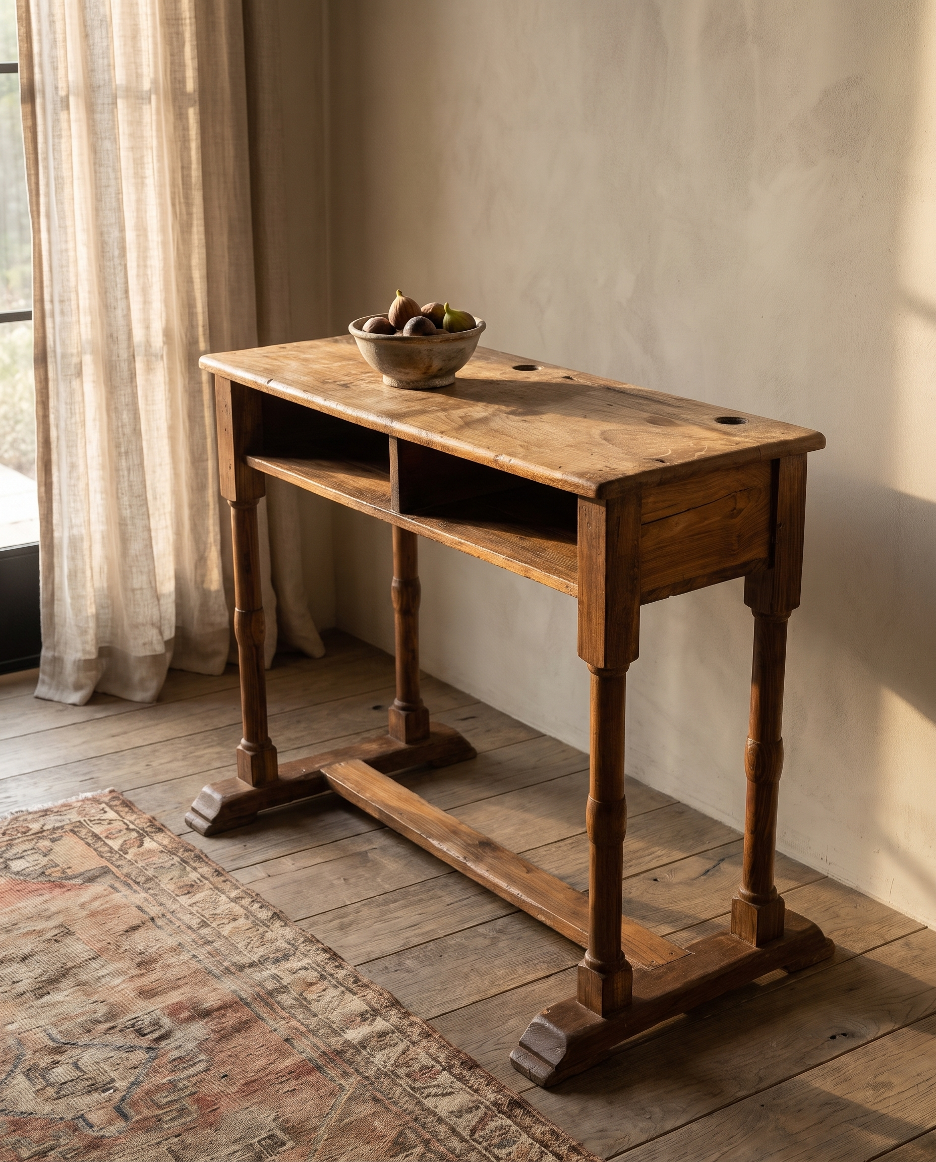 Three-quarter view of the antique school desk showing turned legs and trestle base