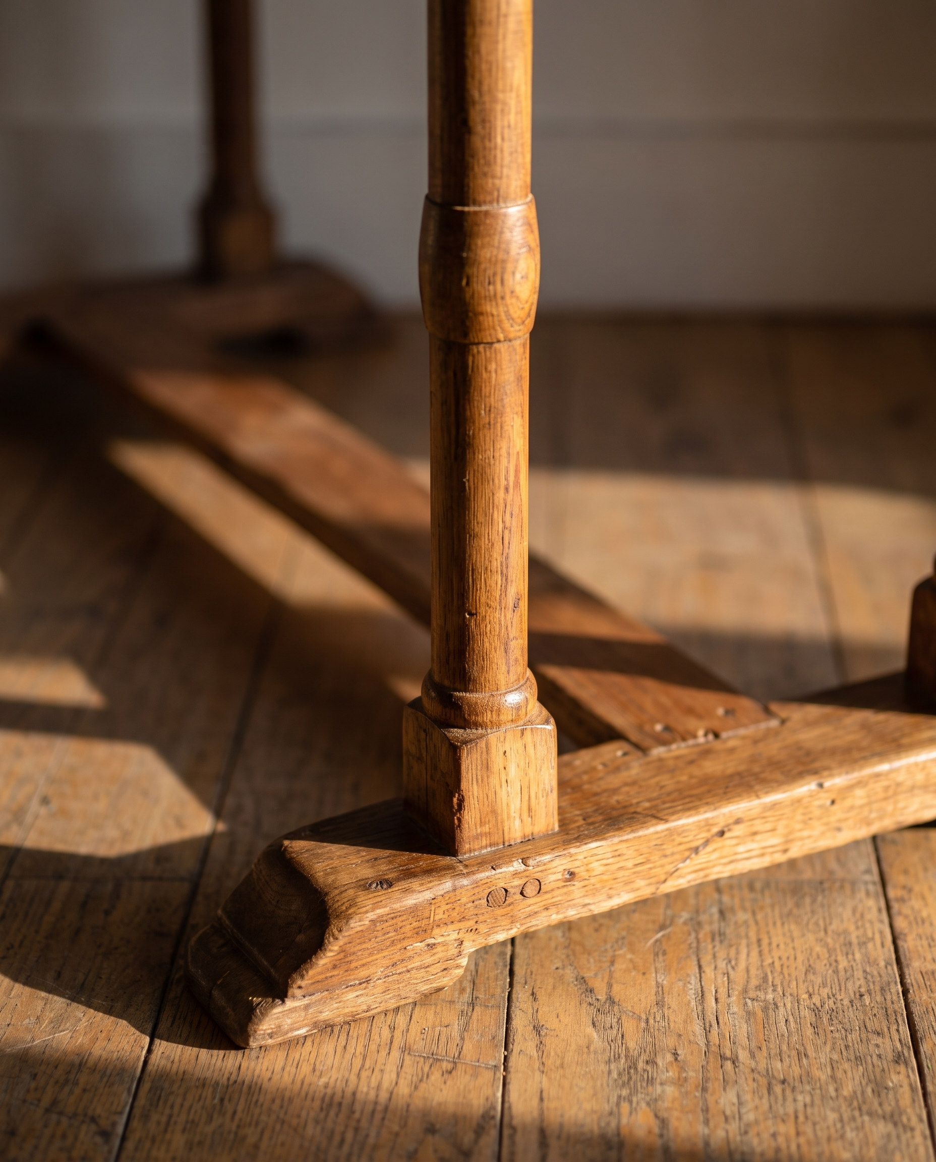 Detail of the hand-turned leg, sled foot, and pegged trestle joinery
