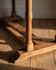 Detail of the hand-turned leg, sled foot, and pegged trestle joinery