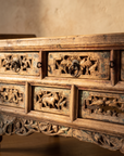 Close-up of the hand-carved openwork apron panels, iron ring pulls and traces of old polychrome