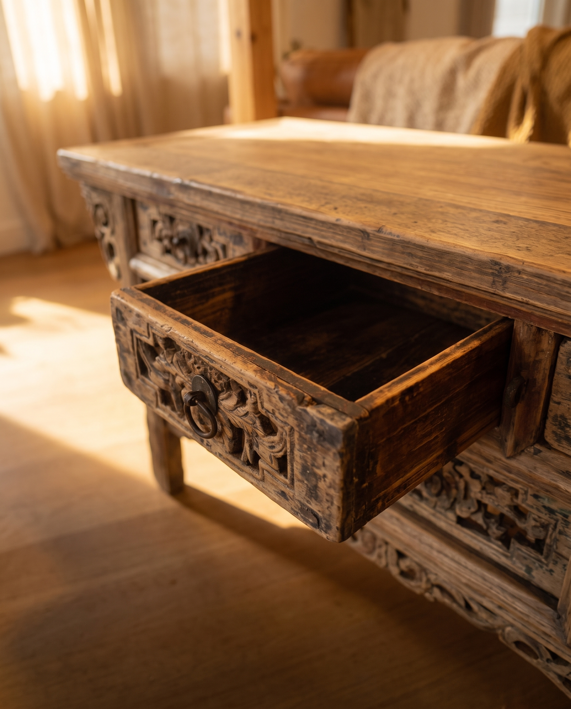 One drawer of the antique altar table pulled open showing the aged solid-wood box