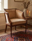 Camel velvet barrel chair in a warm sunlit room