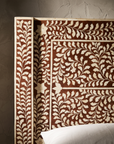 Macro detail of the hand-inlaid bone pattern on the headboard