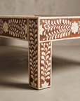 Macro detail of the bone-inlaid leg and rail joinery