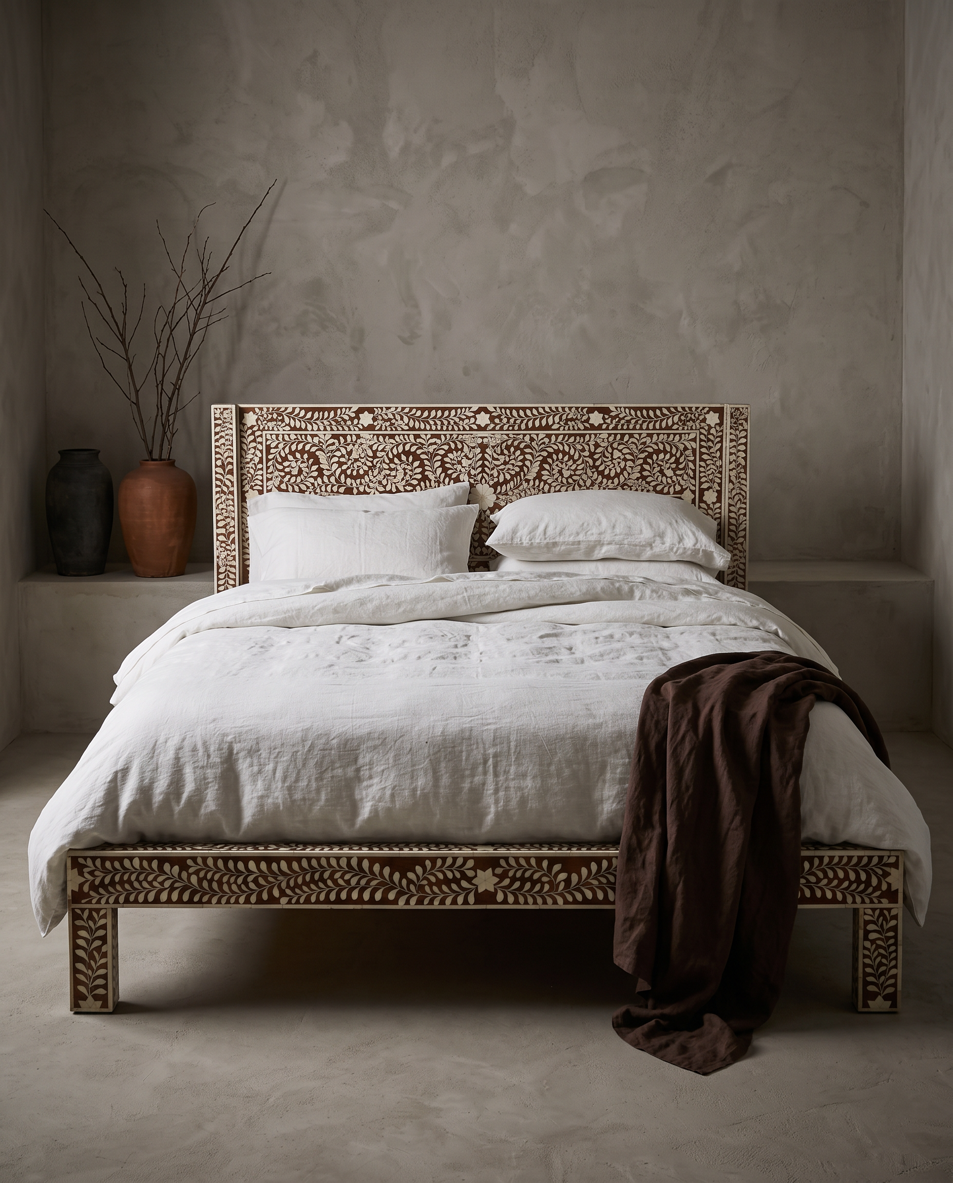 Bone Inlay Bed dressed in white linen bedding, in a greige plaster room
