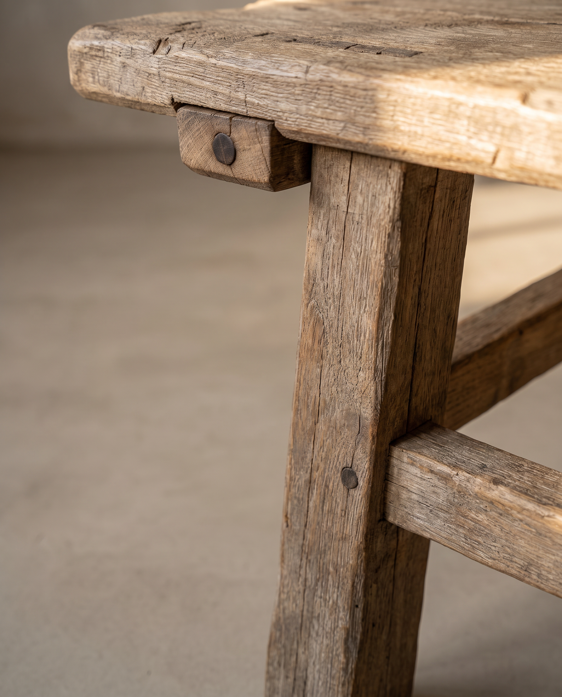 Macro detail of the leg, through-tenon peg, and stretcher joinery