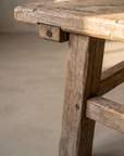 Macro detail of the leg, through-tenon peg, and stretcher joinery
