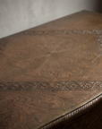 Macro detail of the engraved brass medallion on the top of The Saffron Chest Dresser