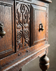 Second detail of the carved floral relief stile and brass hardware