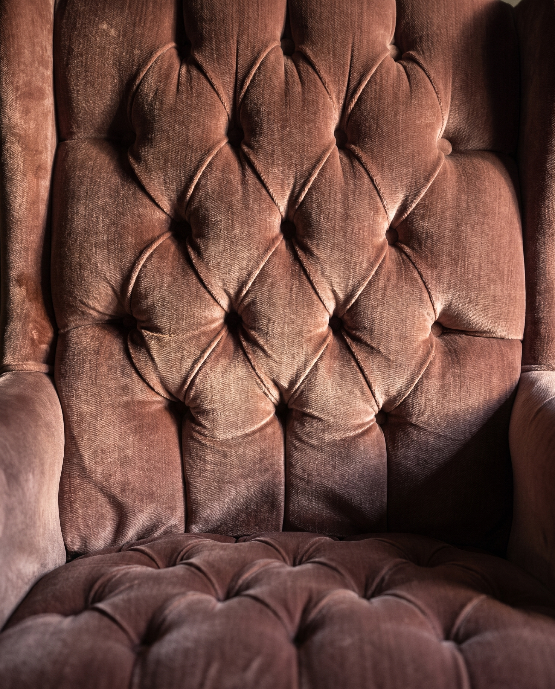 Macro detail of the diamond-tufted back and scalloped seat tufting in dusty rose velvet