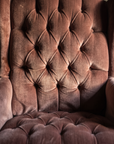 Macro detail of the diamond-tufted back and scalloped seat tufting in dusty rose velvet