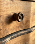Detail of a turned wood knob and the black distressed trim on The Curvy Dresser