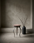 The Iron Lace Table - lifestyle shot with dried branches