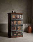 The Verdigris Chest, four-drawer reclaimed wood chest with sea-glass green patina, styled in a greige plaster room