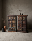 The Verdigris Chest paired with The Sienna Chest, straight-on view in the greige plaster room