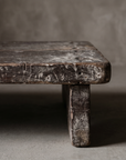 North India bajot detail, close-up of leg and plank-seam corner showing worn teak grain and distressed paint remnants