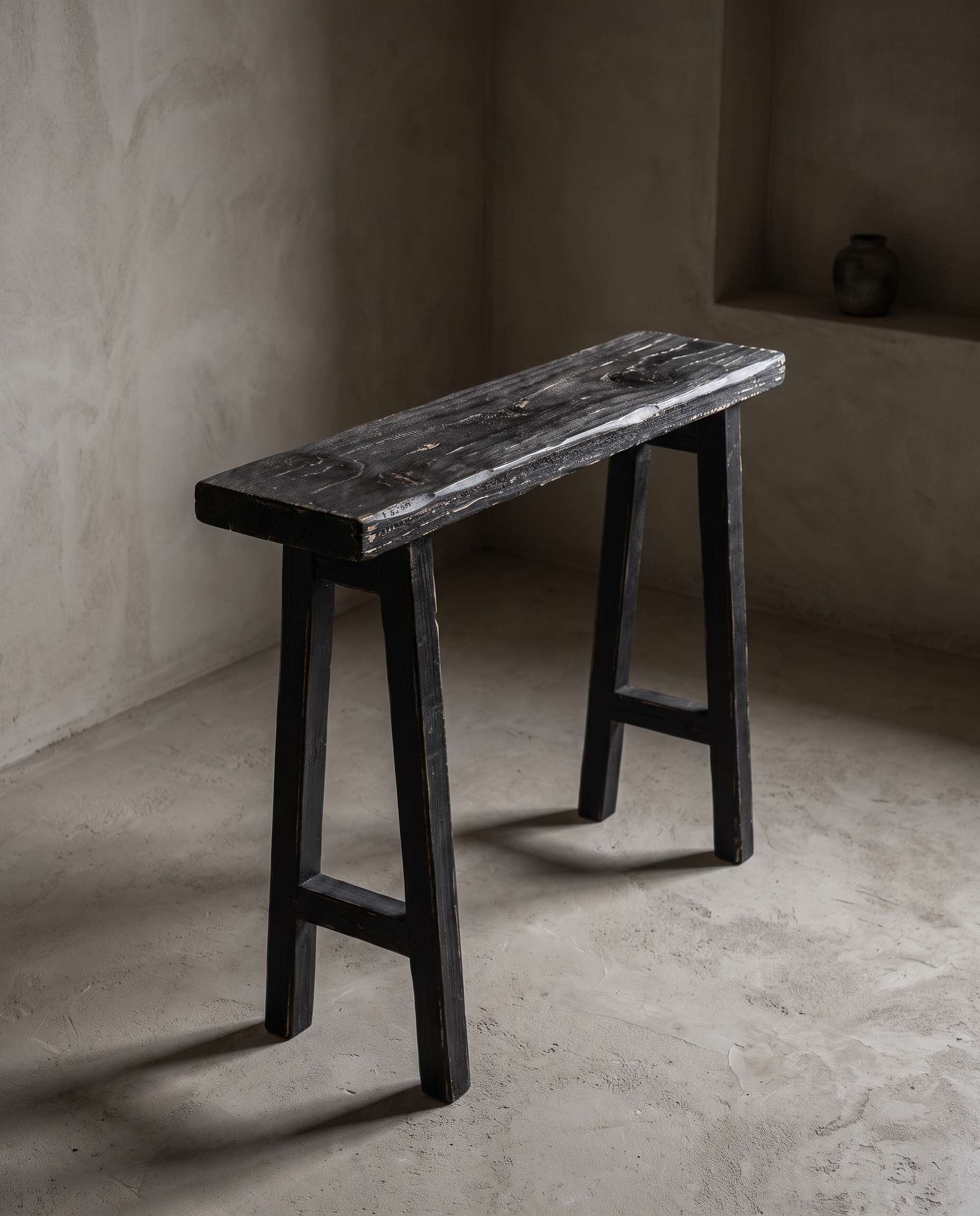 Ebonized reclaimed wood console, three-quarter view, greige plaster room