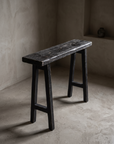 Ebonized reclaimed wood console, three-quarter view, greige plaster room