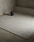 Heathered grey flatweave rug, three-quarter angle showing full shape and proportions