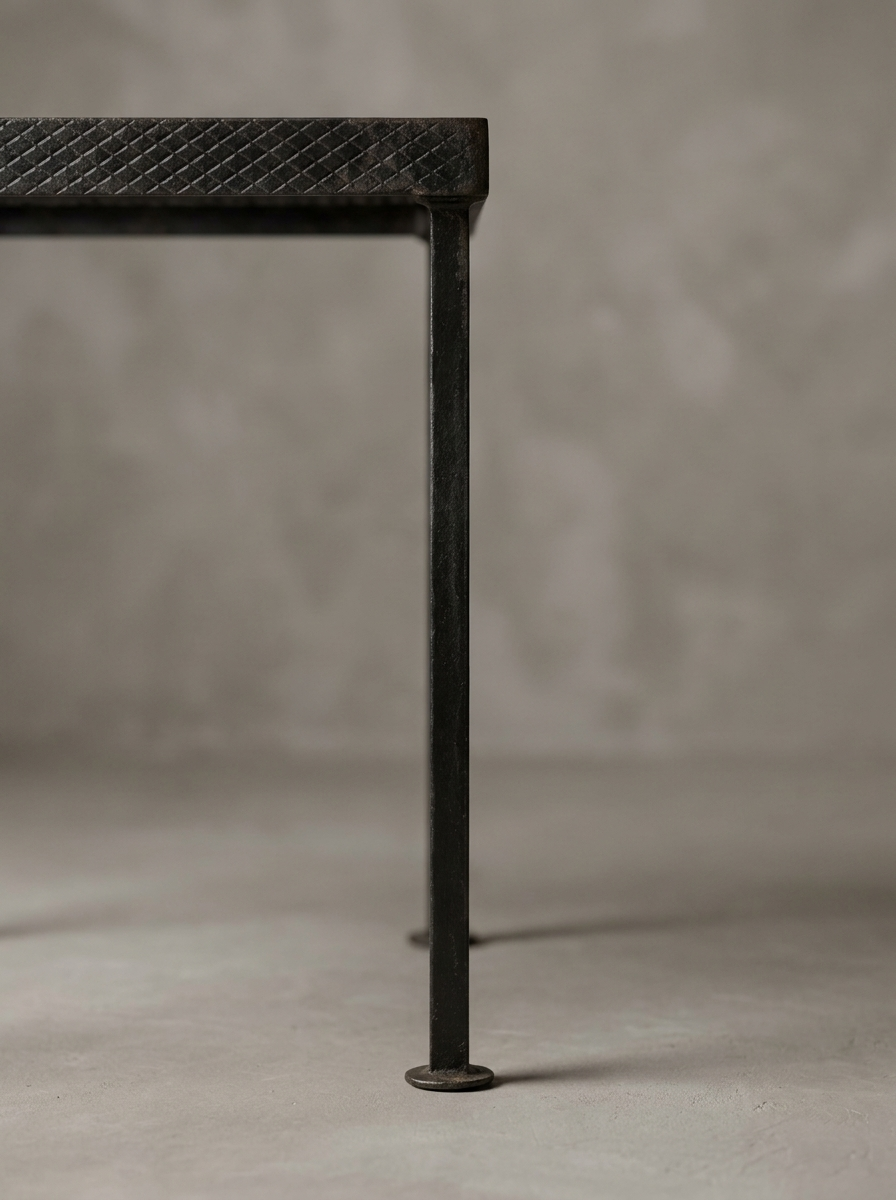 Macro detail of one leg and round foot on the Geometric Lattice grate table