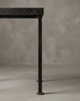 Macro detail of one leg and round foot on the Geometric Lattice grate table