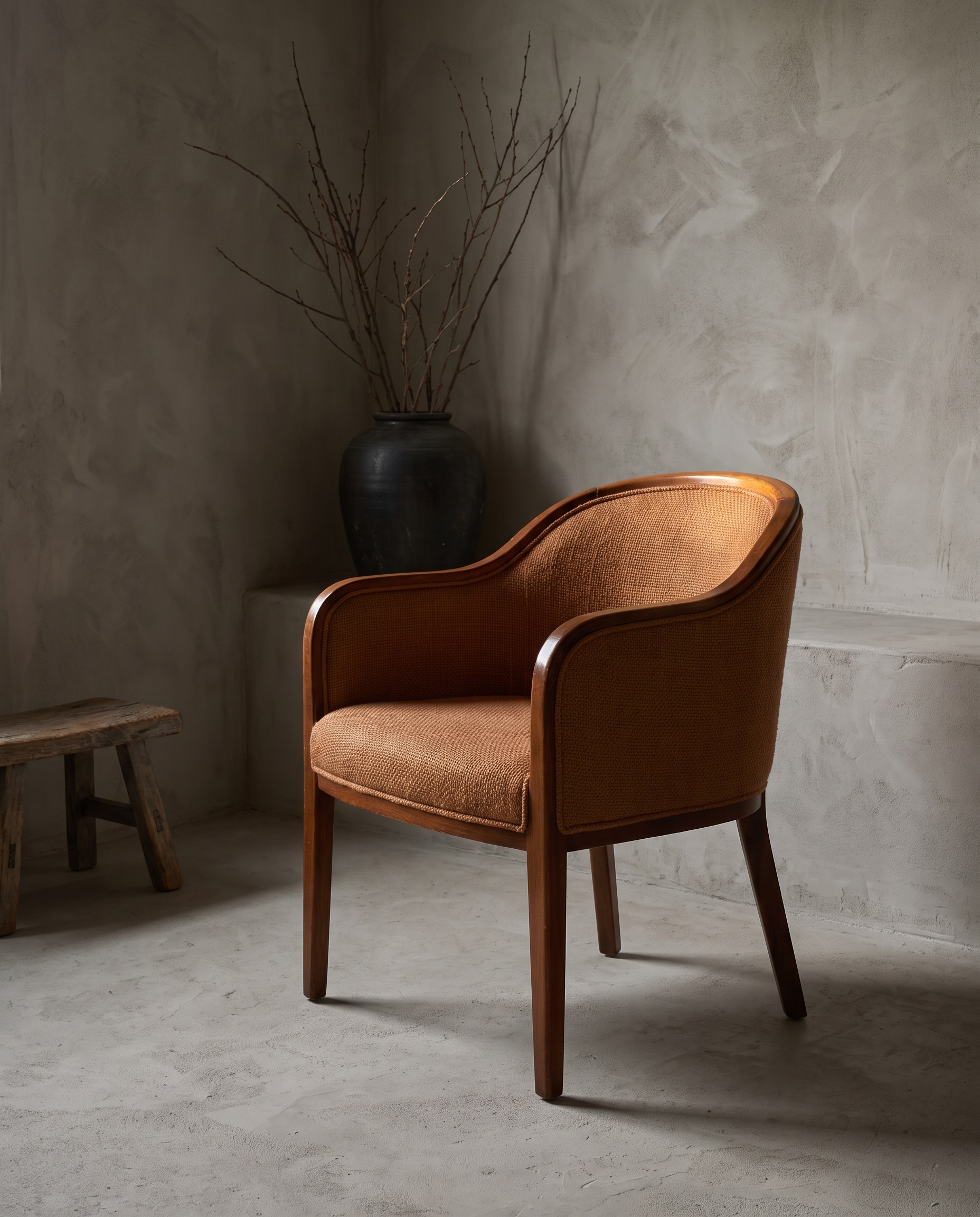 Three-quarter view of a burnt orange woven armchair showing form and construction