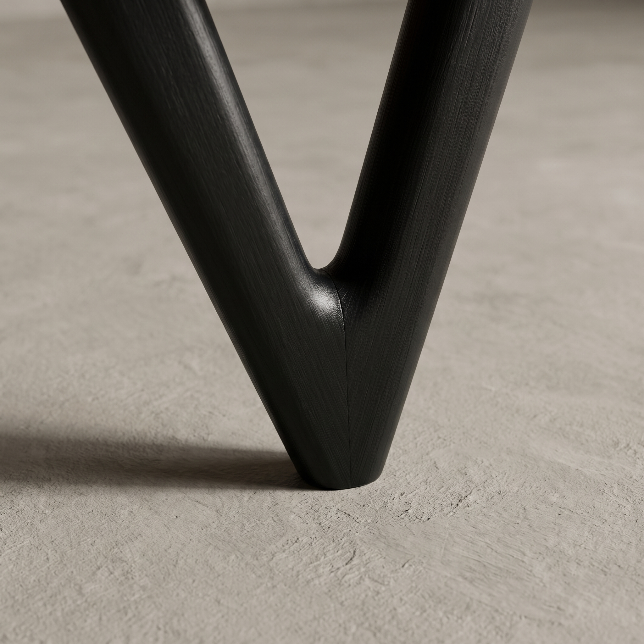 Close up detail of the black boomerang-shaped rear leg