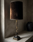 Three-quarter view of the whole lamp, bronze plinth and black marble base up to the velvet shade rim