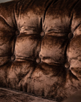 Macro detail of the tufted back cushion showing all six self-covered buttons and the crushed chocolate velvet nap