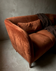 Macro of the curved arm shell in raking light, welt cord and directional velvet nap in relief