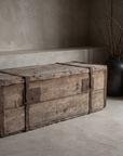 Antique pine trunk three-quarter view with stoneware vessels and dried branches
