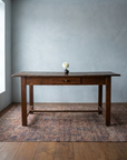 Front view of The Hawthorn Desk showing its full 88 inch length, single drawer with wooden pull, square tapered legs and low stretcher
