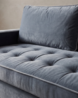 Macro detail of the biscuit-tufted velvet seat cushion and piping
