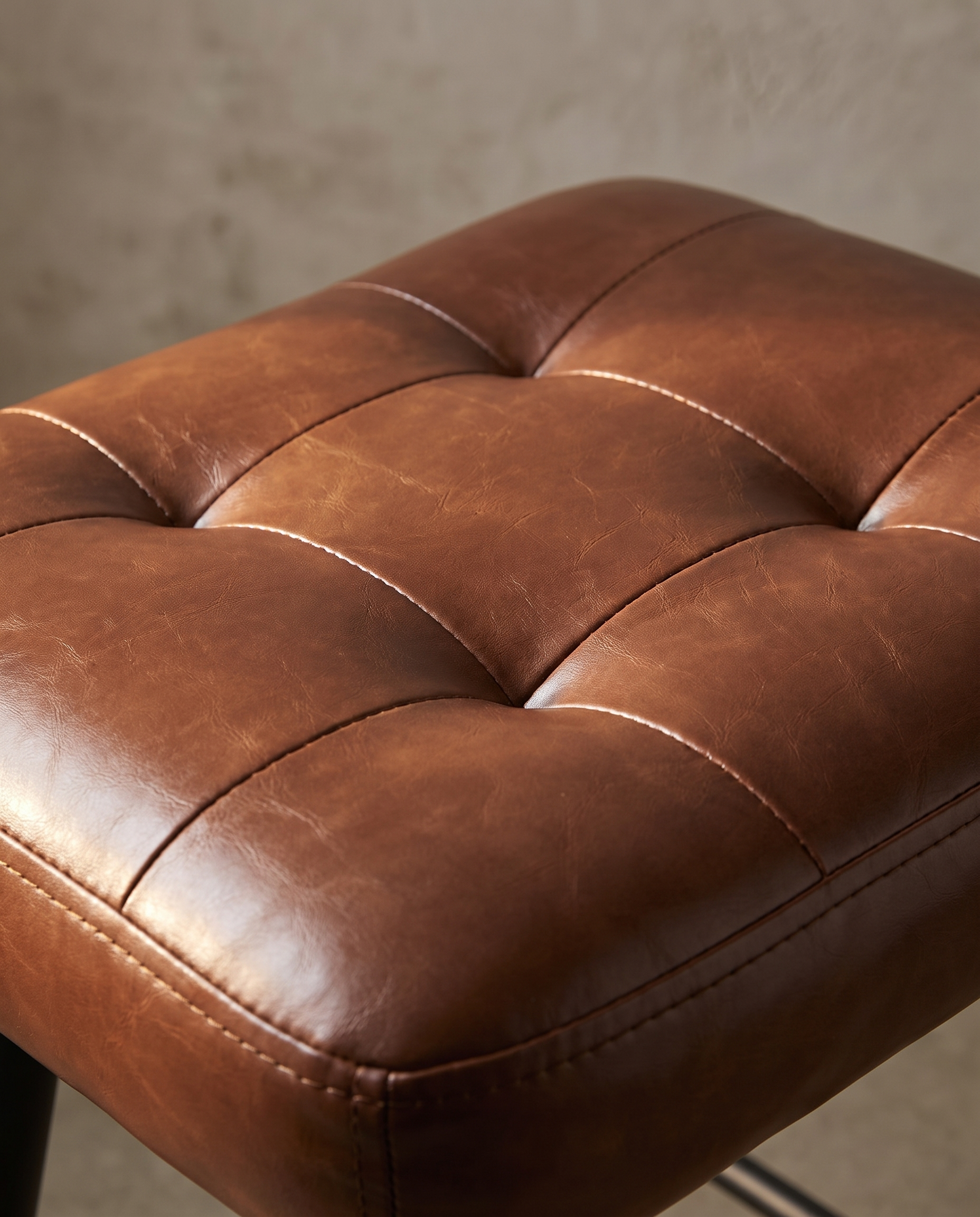 Alternate macro detail of the diamond tufted cognac pleather seat