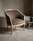 Wheat motif carved bergere chair, three-quarter angle