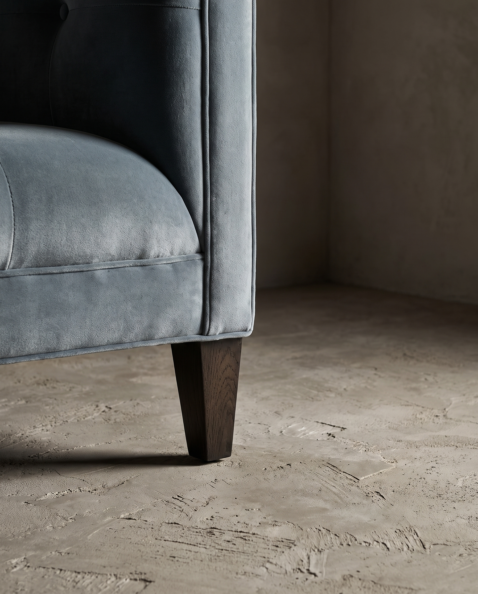 Detail of tapered wood leg and track arm base with welt seam