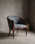 Single grey-blue bouclé barrel-back chair, three-quarter view showing full form