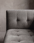 Macro detail of the biscuit tufting grid across the back and seat