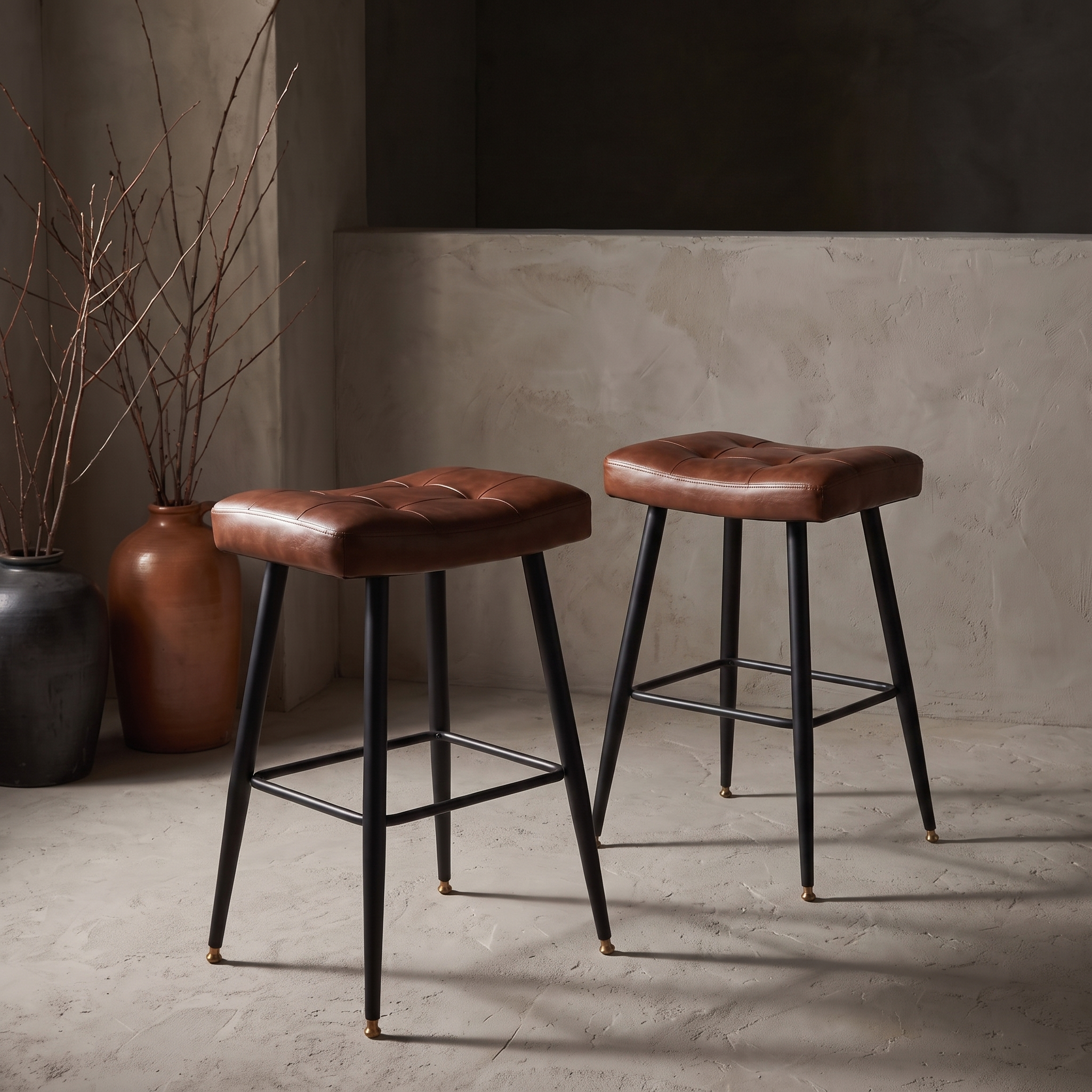 Pleather saddle counter stools, pair, against raw plaster wall