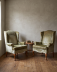 The pair styled in a lived-in reading nook with a side table and books