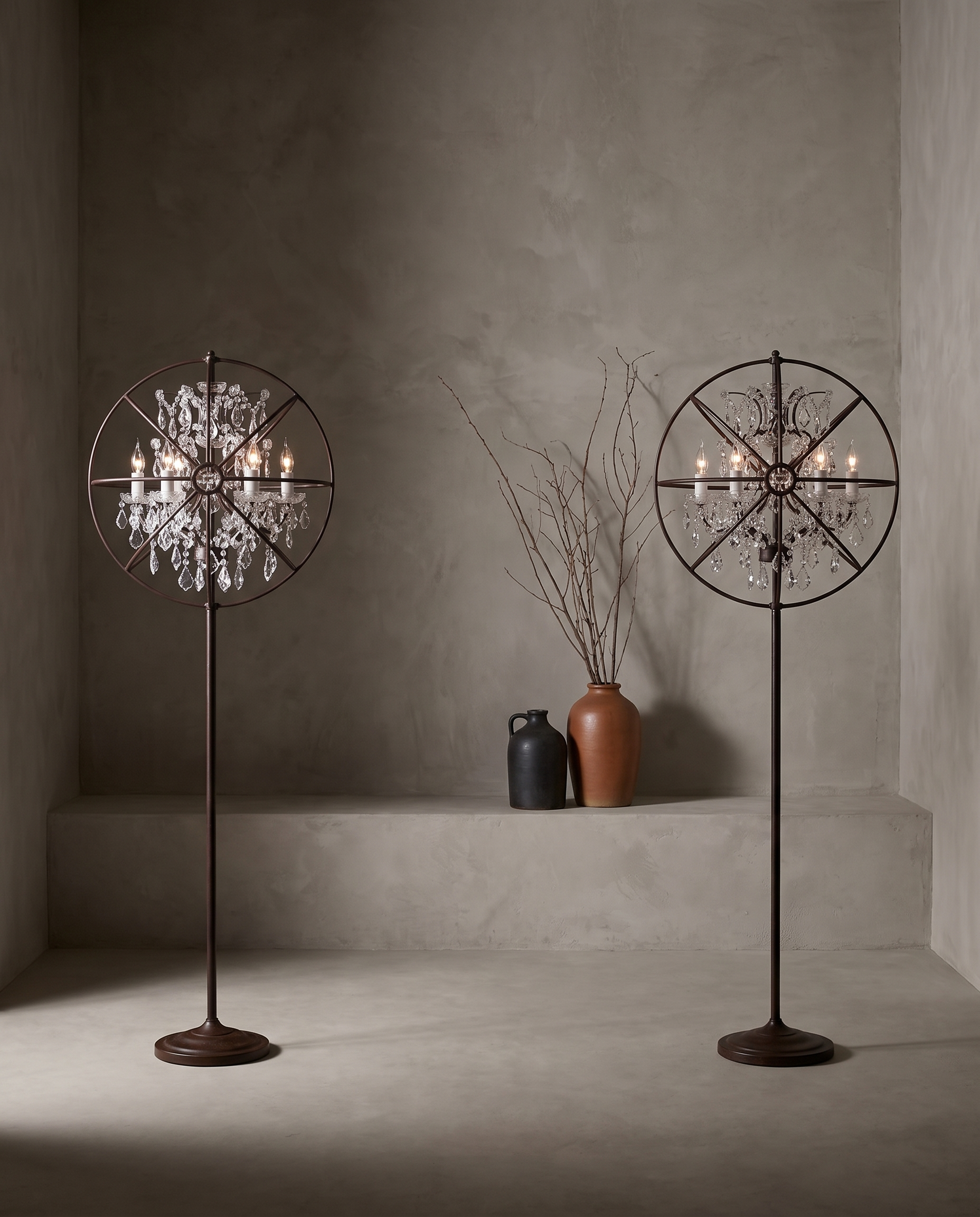 Pair of Crystal Orb floor lamps in antique rust, styled in a plaster room with stoneware vessels and dried branches