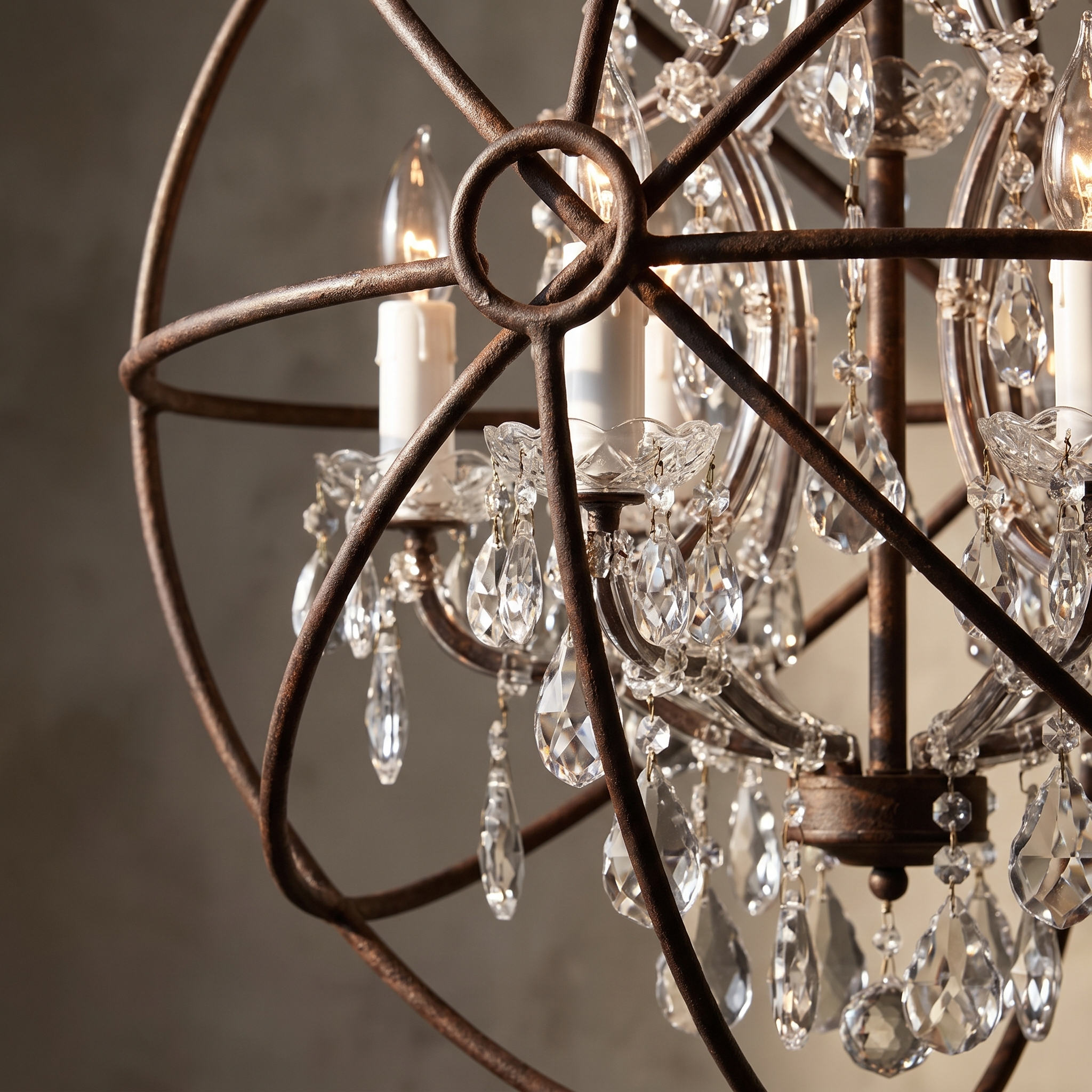 Macro detail of the Crystal Orb floor lamp's iron frame, white candle sleeves, and hand-polished crystal