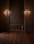 Pair of Gyro Crystal Floor Lamps by Timothy Oulton in antique rust, glowing warm and sultry over rich reclaimed redwood floors