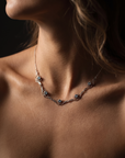 Model wearing Scrolled Gold Necklace with Five Stones