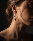 Model wearing Garnet Whiplash Earrings